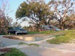 Plymouths are parked on the lot of a home destroyed by Katrina.