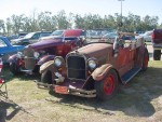 We found The Beverly Hillbillies car parked at the Coast Coliseum. There was even a miniature still mounted on the back of it.