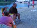 Joe and Maggie watch a singer on stage by the campground pond.