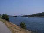 A ship makes its way along the Cape Cod Canal. The Sagamore bridge is in the distance.